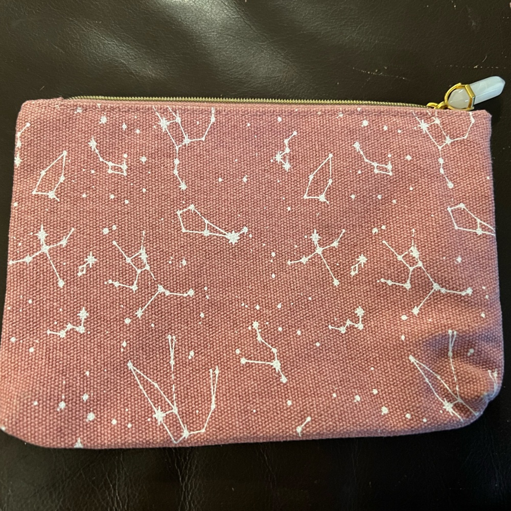 Ipsy cosmetics bag in pink with white celestial/astrological like patterns